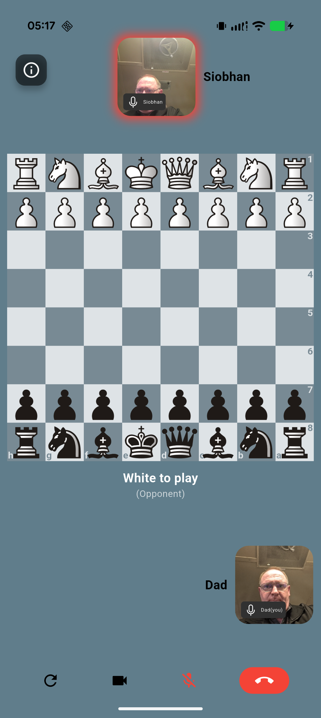 In-game view showing two players on video chat while playing chess
